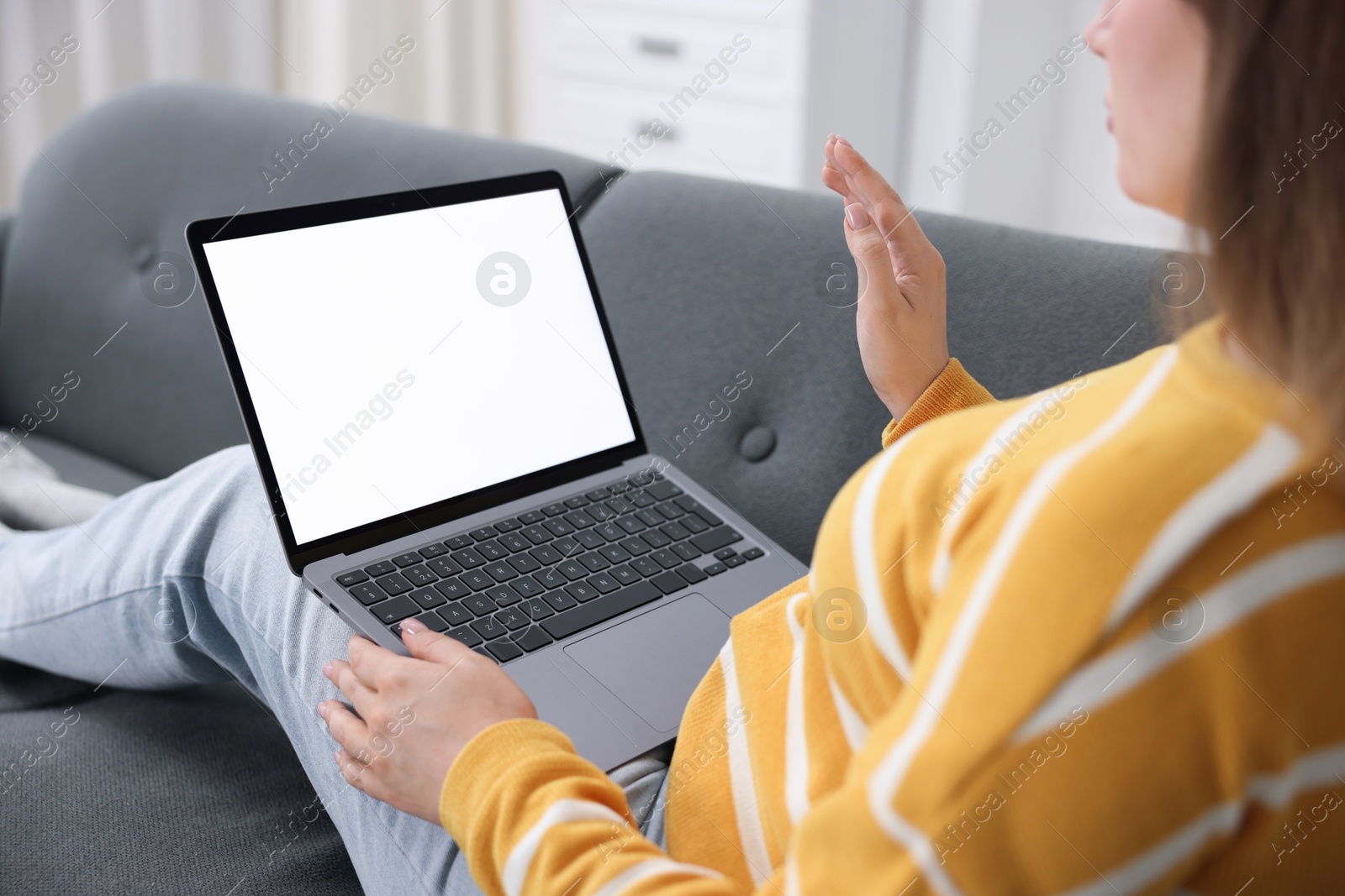 Photo of Woman having online consultation with doctor via laptop on sofa at home, closeup
