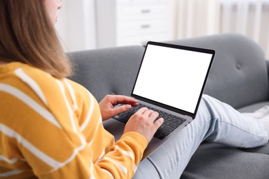 Photo of Woman having online consultation with doctor via laptop on sofa at home, closeup