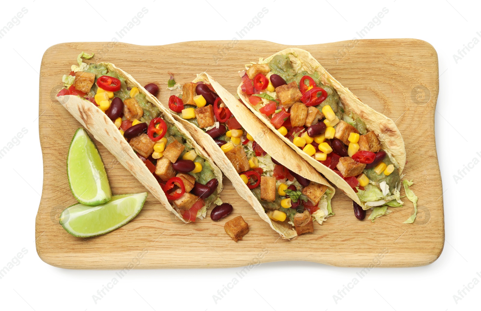 Photo of Tasty vegetarian tacos with beans, tofu, vegetables, guacamole and lime isolated on white, top view
