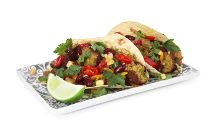 Photo of Tasty vegetarian tacos with falafel, tofu, beans, vegetables and lime isolated on white