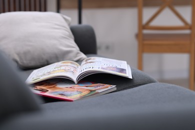 Photo of Lifestyle magazines on sofa indoors, closeup view