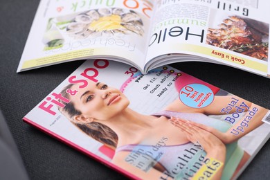Photo of Lifestyle magazines on sofa indoors, closeup view