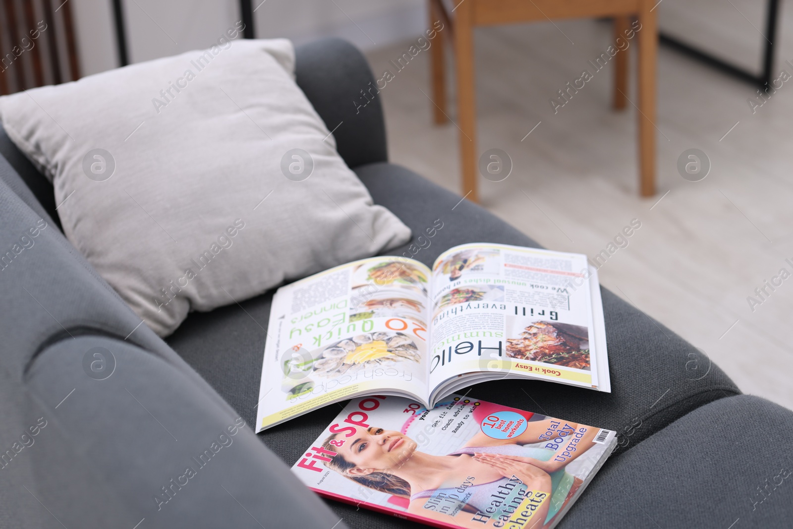 Lifestyle magazines on sofa indoors, closeup view Photo of Lifestyle magazines on sofa indoors, closeup view