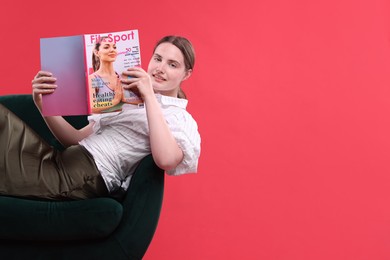 Photo of Woman with lifestyle magazine on armchair against red background, space for text