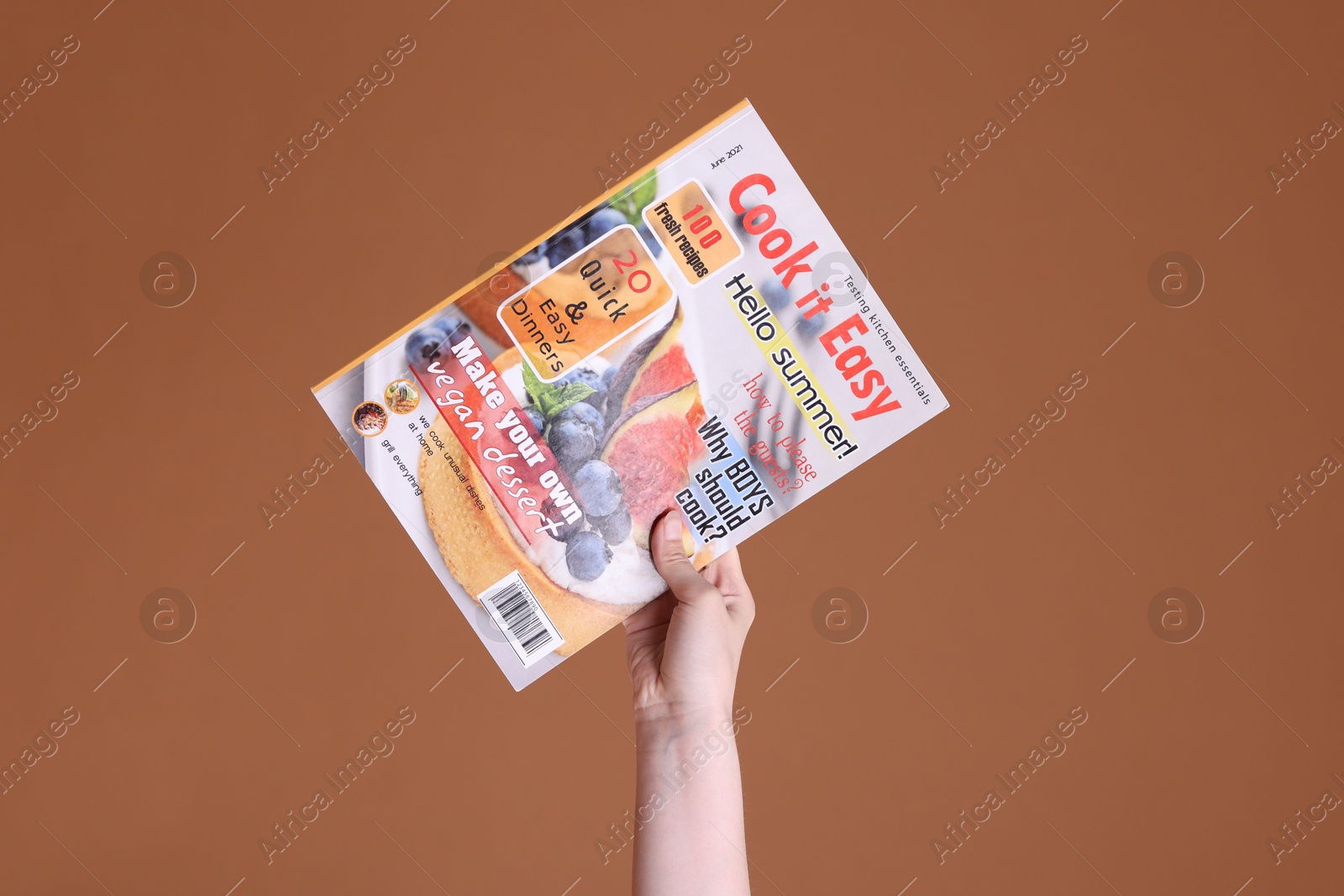 Woman with lifestyle magazine on brown background, closeup Photo of Woman with lifestyle magazine on brown background, closeup