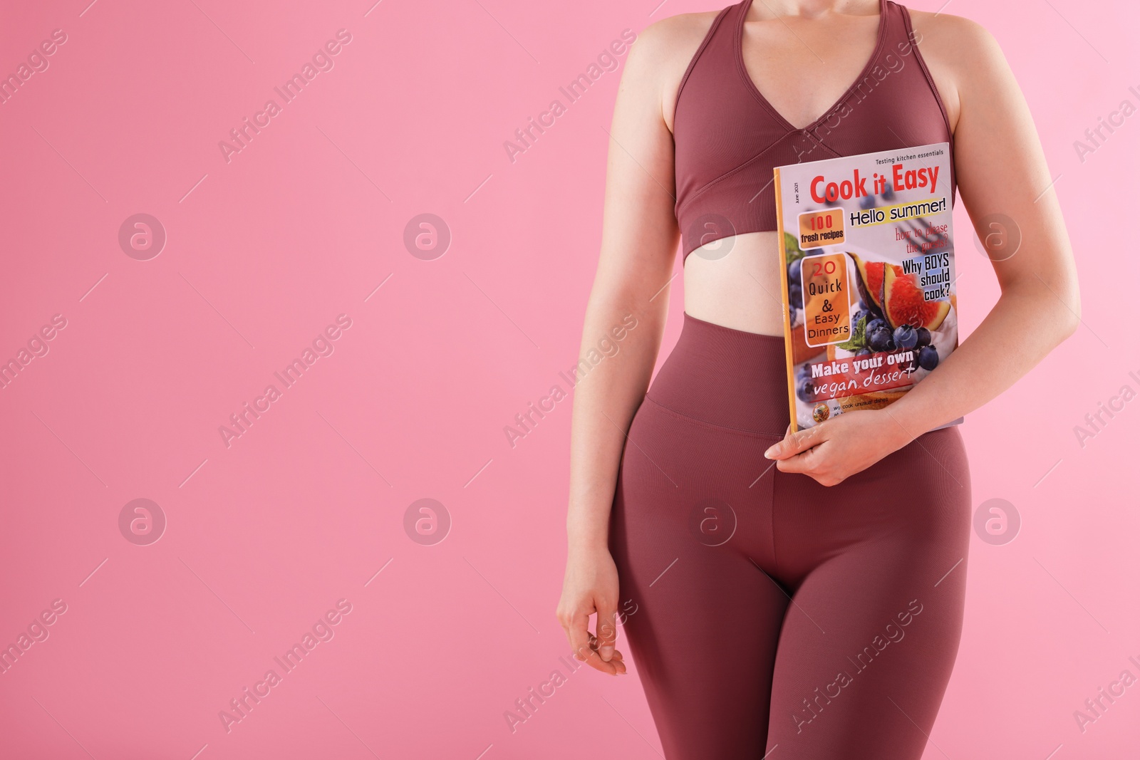 Woman with lifestyle magazine on pink background, closeup. Space for text Photo of Woman with lifestyle magazine on pink background, closeup. Space for text