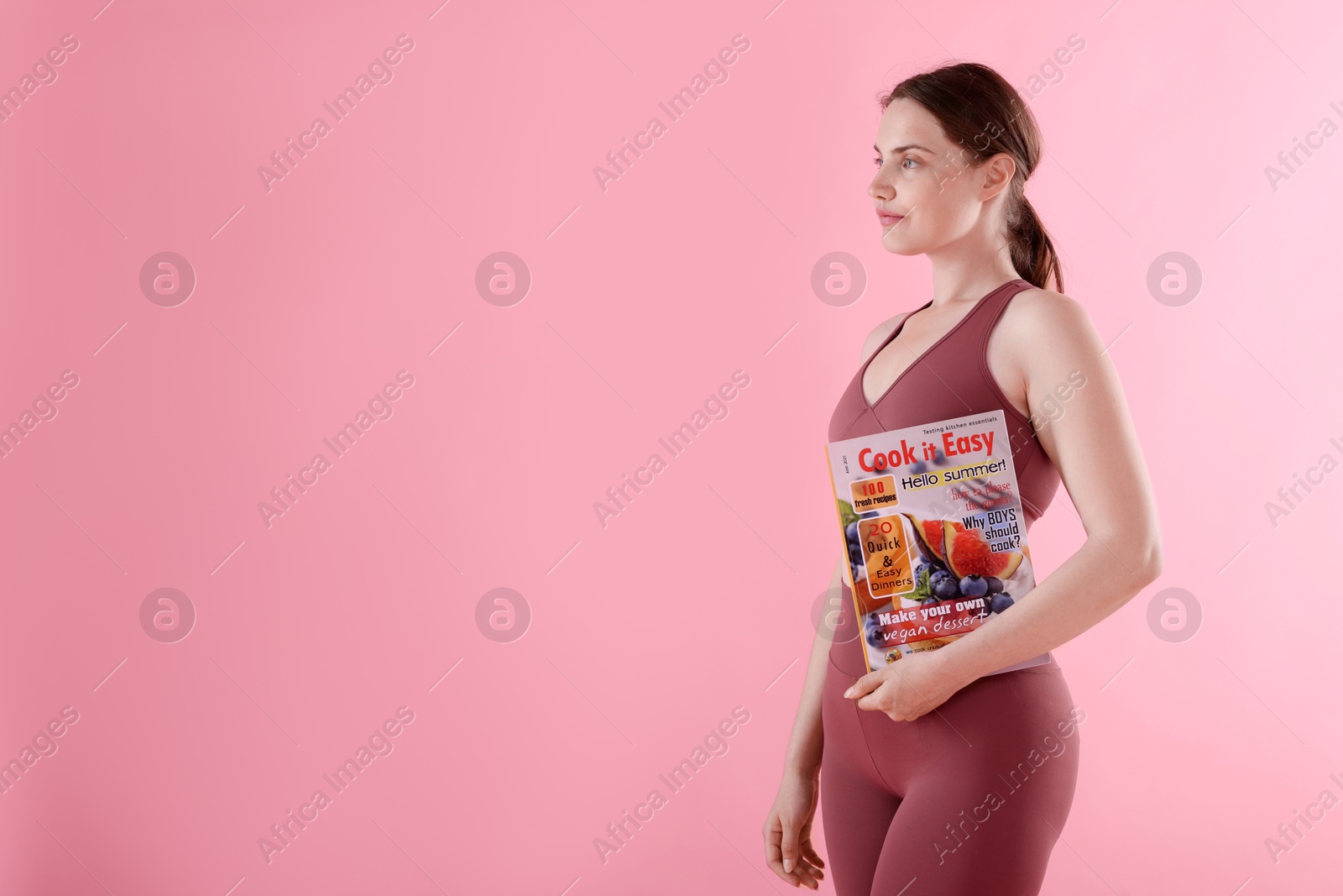 Woman with lifestyle magazine on pink background, space for text Photo of Woman with lifestyle magazine on pink background, space for text