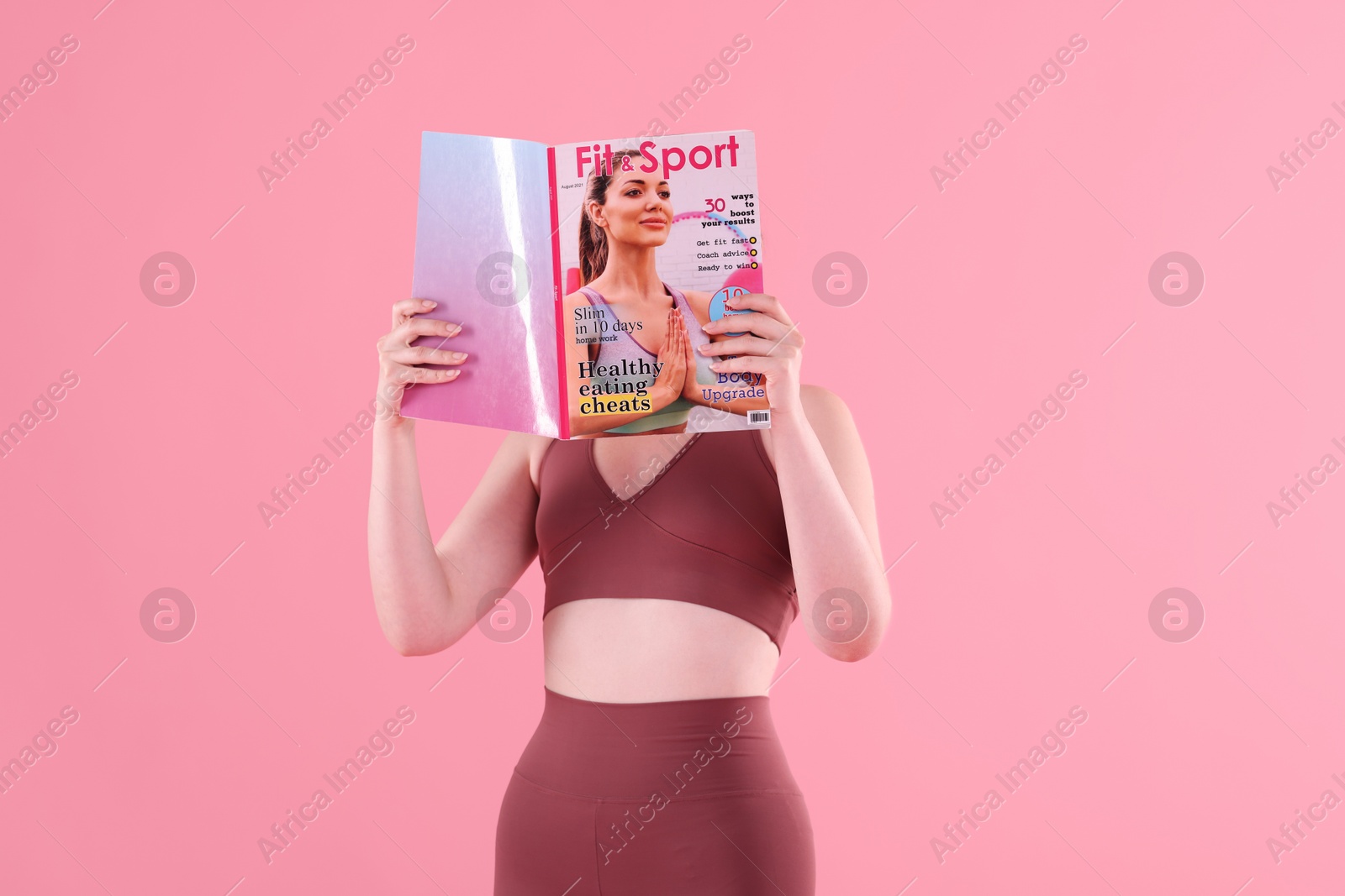 Woman with lifestyle magazine on pink background Photo of Woman with lifestyle magazine on pink background