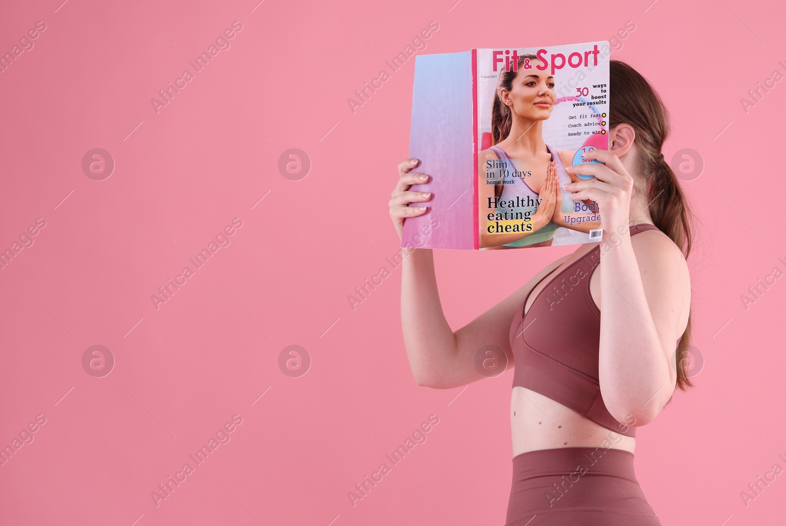 Woman with lifestyle magazine on pink background, space for text Photo of Woman with lifestyle magazine on pink background, space for text
