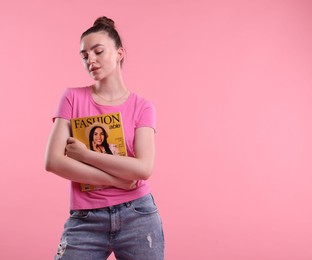 Photo of Woman with fashion magazine on pink background