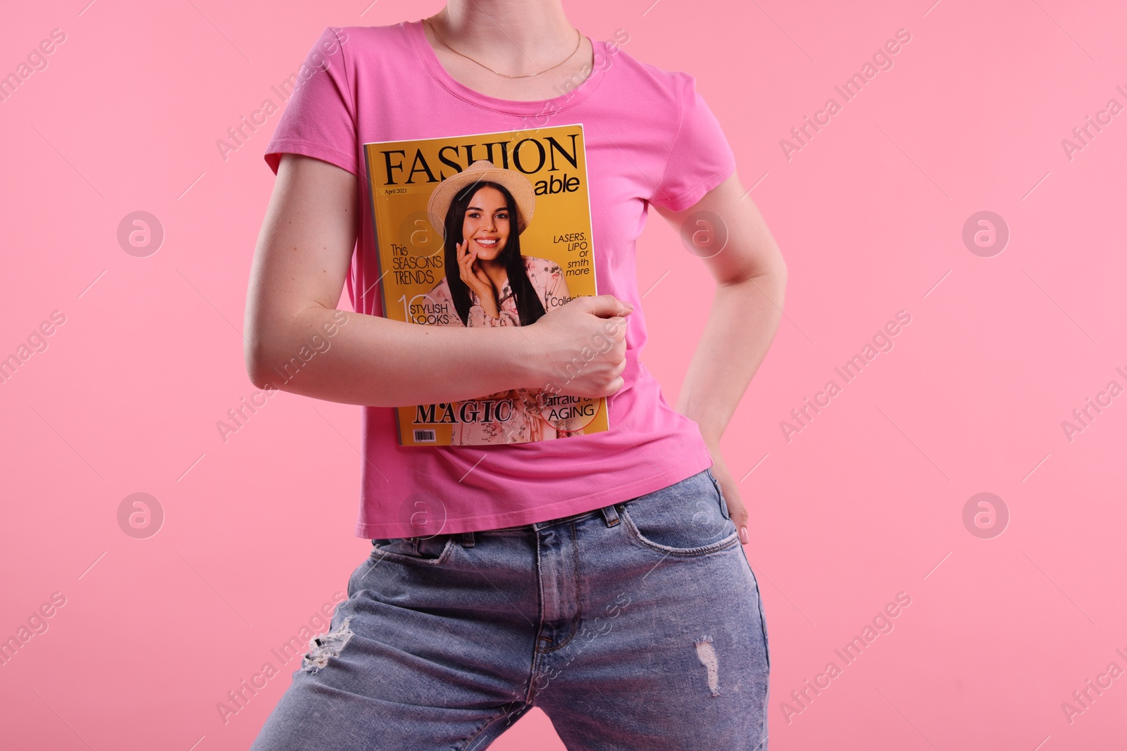 Woman with fashion magazine on pink background, closeup Photo of Woman with fashion magazine on pink background, closeup
