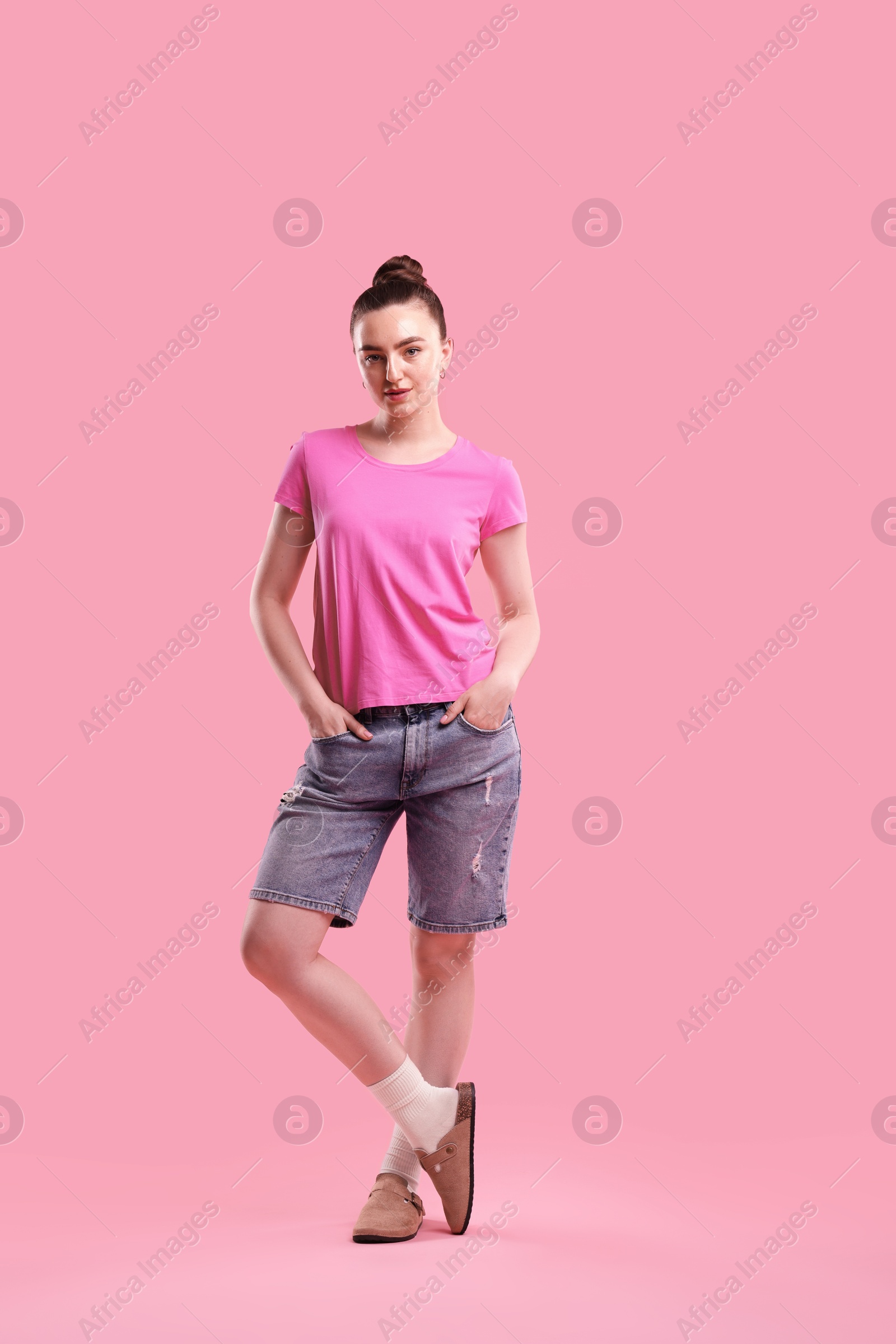 Portrait of beautiful woman on pink background Photo of Portrait of beautiful woman on pink background