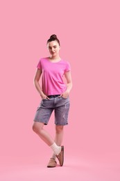 Photo of Portrait of beautiful woman on pink background
