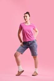 Photo of Portrait of beautiful woman on pink background