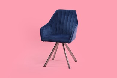 Photo of One comfortable blue armchair on pink background