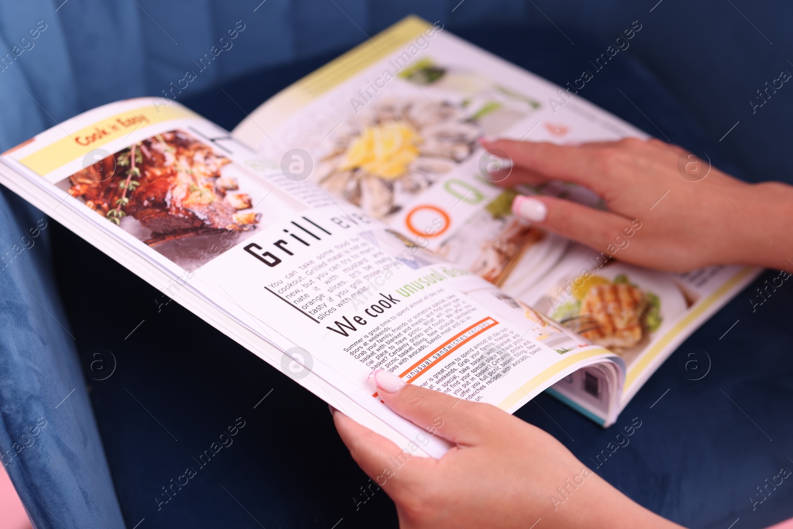 Woman with lifestyle magazine on armchair, closeup Photo of Woman with lifestyle magazine on armchair, closeup