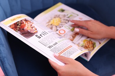 Photo of Woman with lifestyle magazine on armchair, closeup