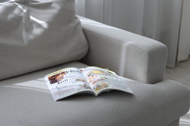 Photo of Lifestyle magazines on sofa indoors, closeup view