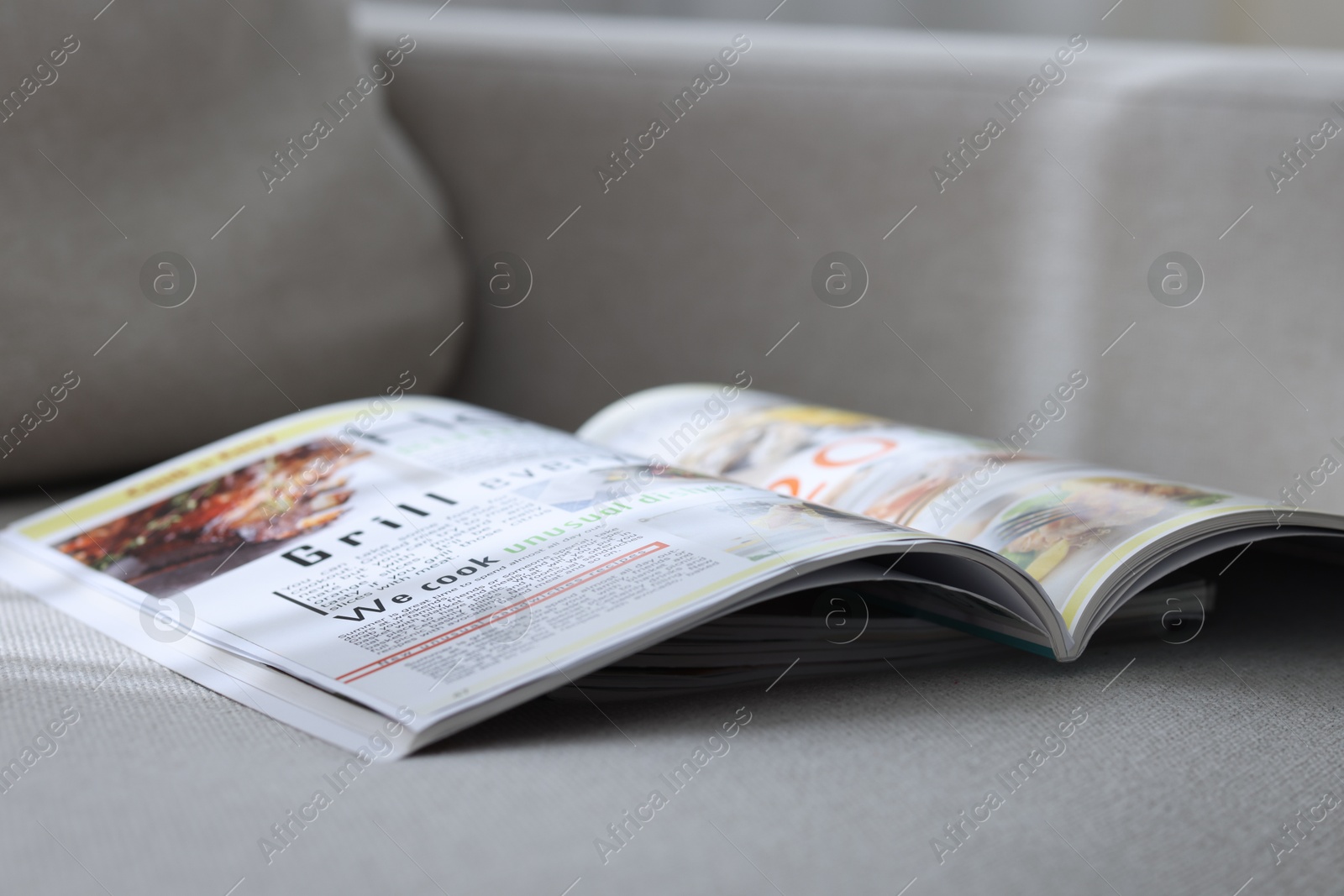 Lifestyle magazines on sofa indoors, closeup view Photo of Lifestyle magazines on sofa indoors, closeup view