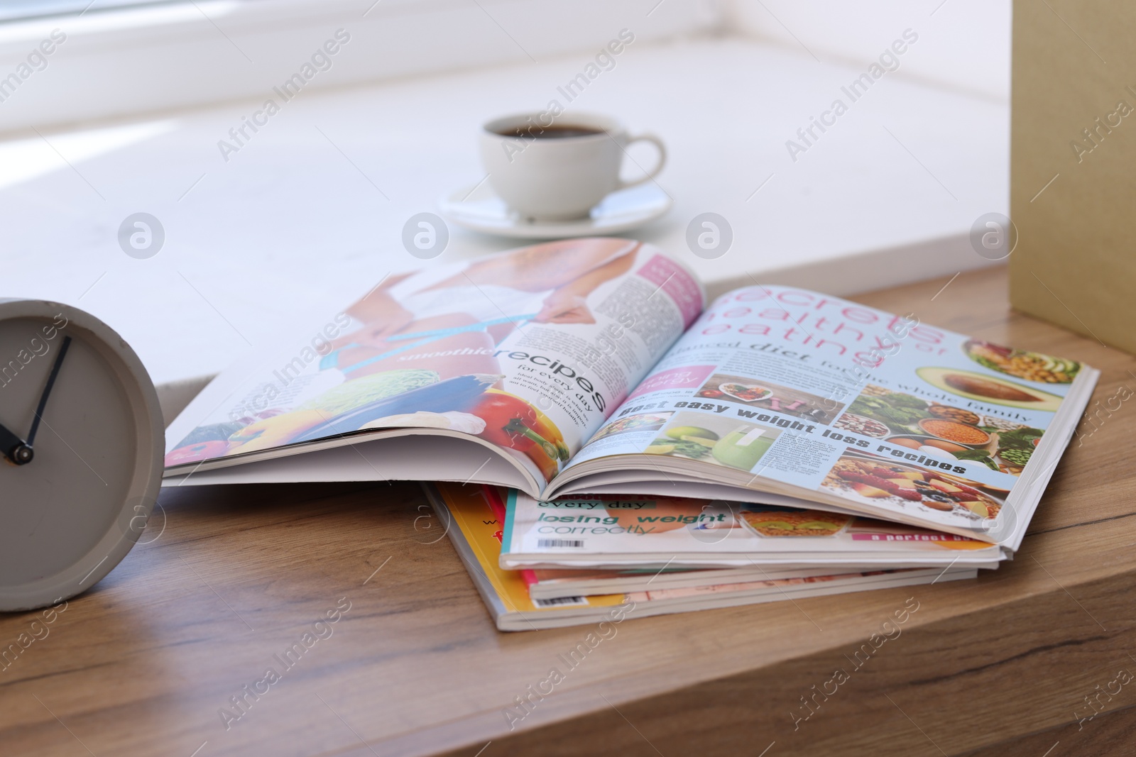 Photo of Lifestyle magazines on wooden table indoors, closeup