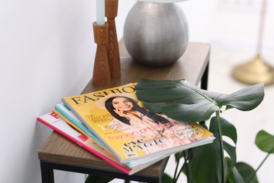 Photo of Lifestyle magazines on wooden table indoors, closeup
