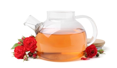 Photo of Tasty rose tea in glass teapot and flowers isolated on white