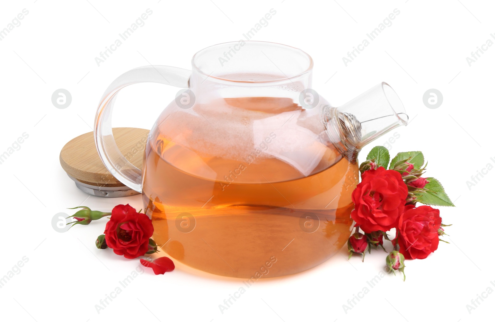 Photo of Tasty rose tea in glass teapot and flowers isolated on white