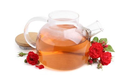 Photo of Tasty rose tea in glass teapot and flowers isolated on white