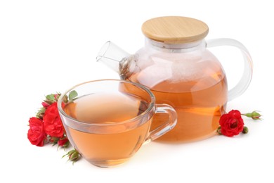 Photo of Tasty rose tea in glass cup, teapot and flowers isolated on white