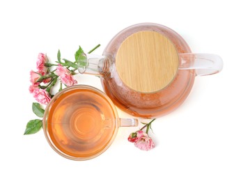 Photo of Tasty rose tea in glass cup, teapot and flowers isolated on white, top view