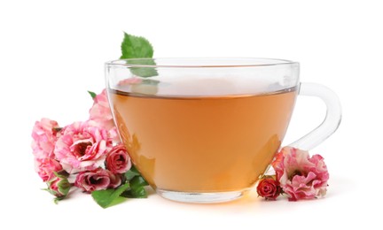 Photo of Tasty rose tea in glass cup and flowers isolated on white