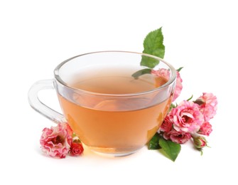 Photo of Tasty rose tea in glass cup and flowers isolated on white