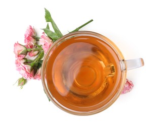 Photo of Tasty rose tea in glass cup and flowers isolated on white, top view