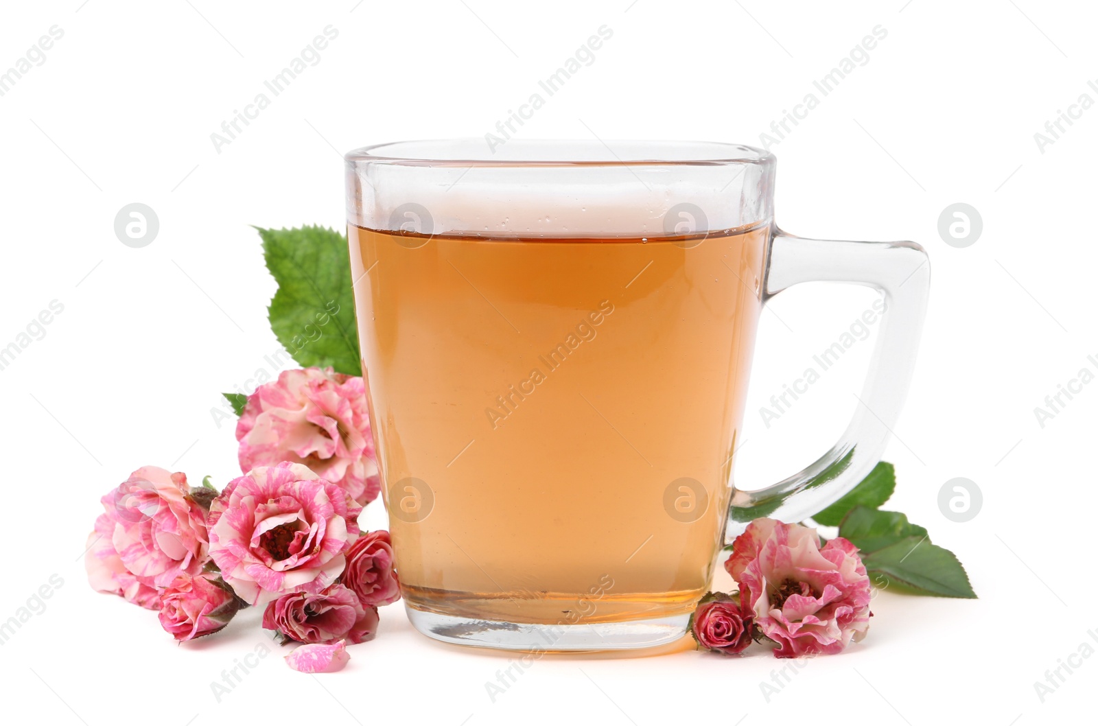 Photo of Tasty rose tea in glass cup and flowers isolated on white