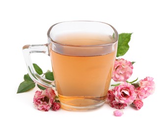 Photo of Tasty rose tea in glass cup and flowers isolated on white