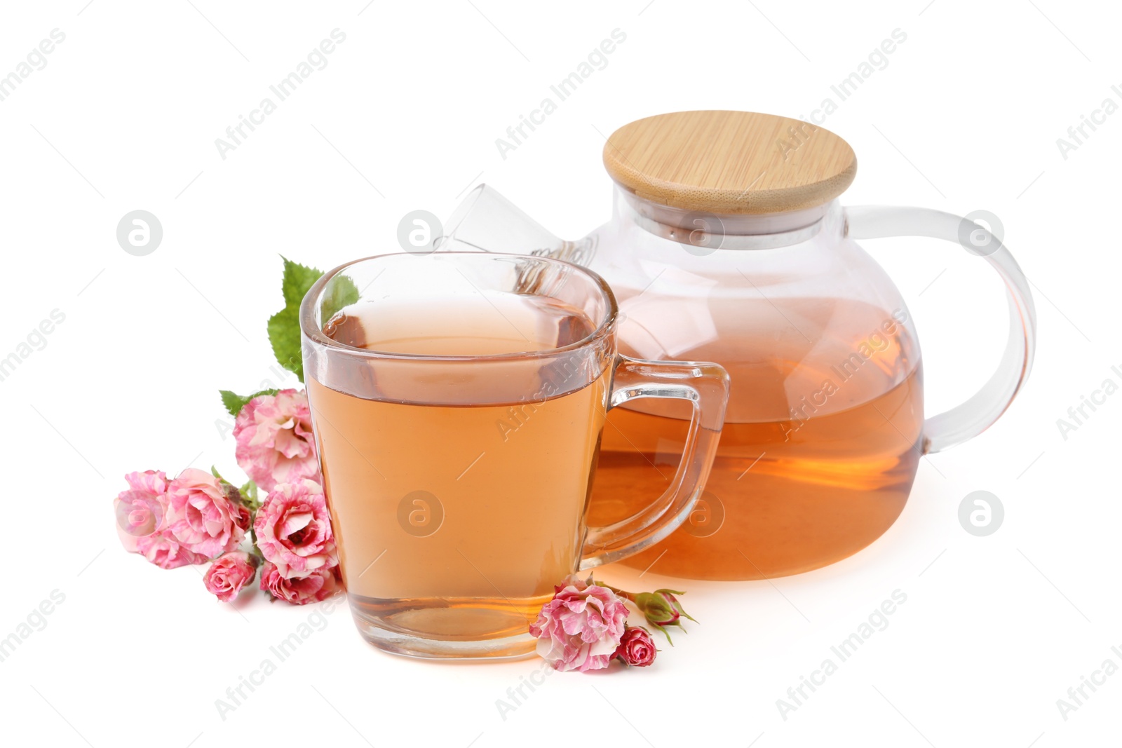 Photo of Tasty rose tea in glass cup, teapot and flowers isolated on white