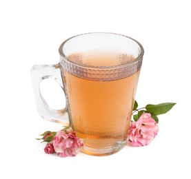 Photo of Tasty rose tea in glass cup and flowers isolated on white