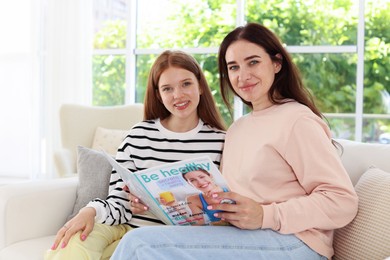 Photo of Portrait of mother and her teenage daughter at home