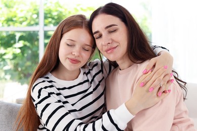 Photo of Mother and her teenage daughter spending time together at home