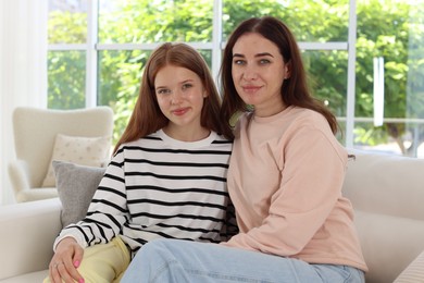 Photo of Portrait of mother and her teenage daughter at home