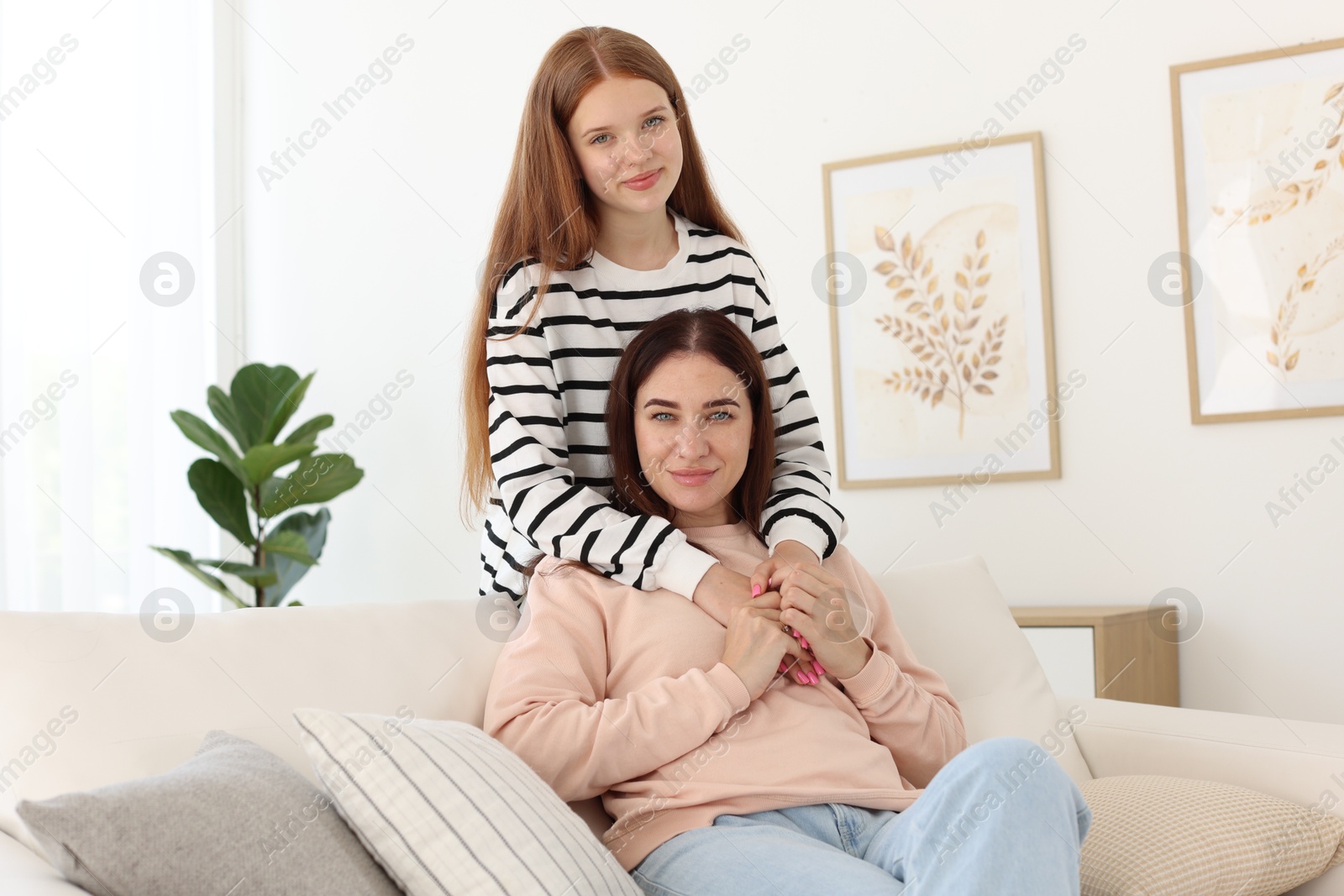 Photo of Portrait of mother and her teenage daughter at home