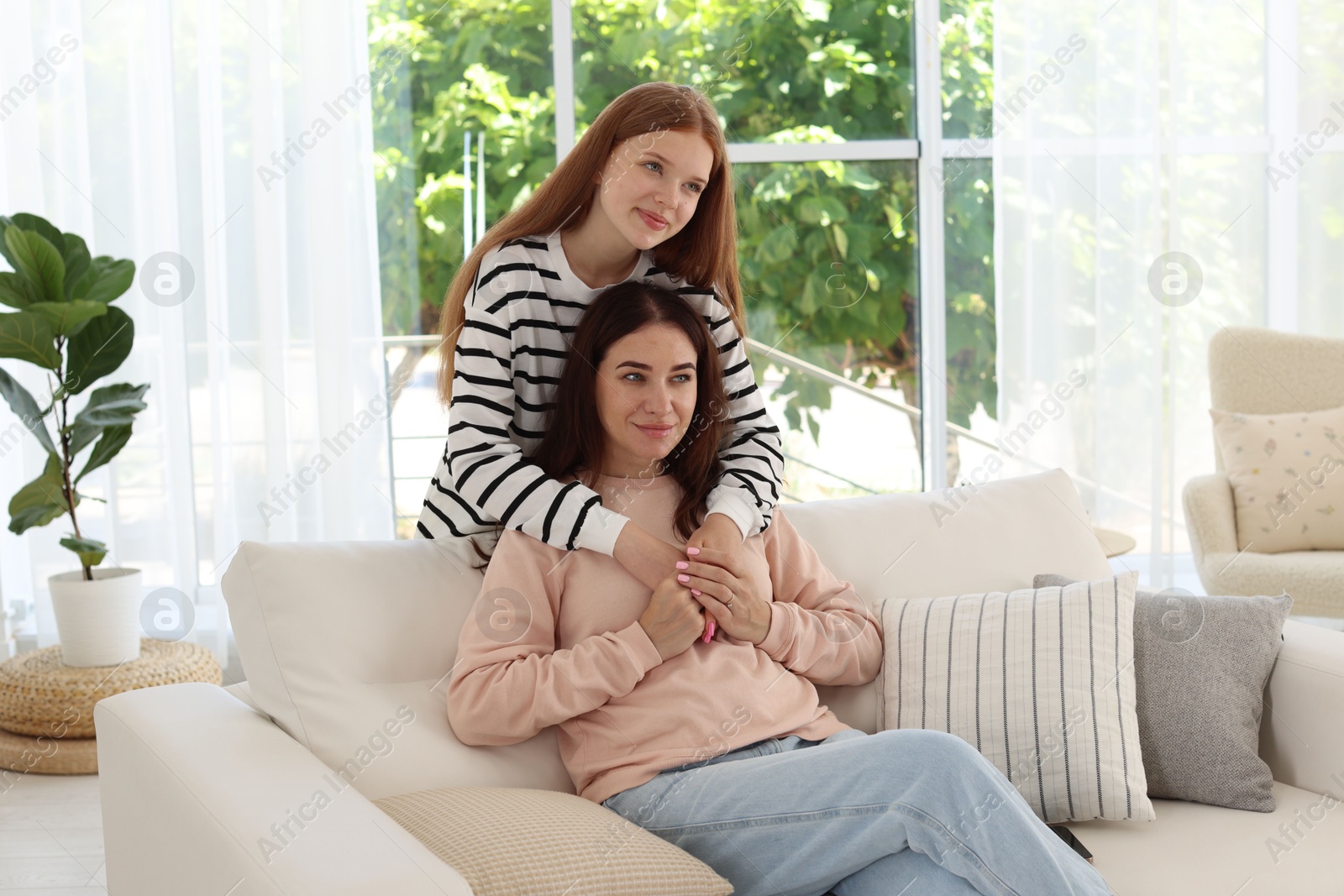 Photo of Portrait of mother and her teenage daughter at home