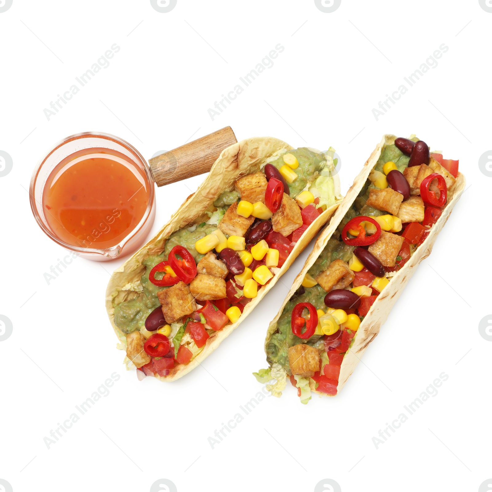 Photo of Tasty vegetarian tacos with beans, tofu, vegetables and sauce isolated on white, top view