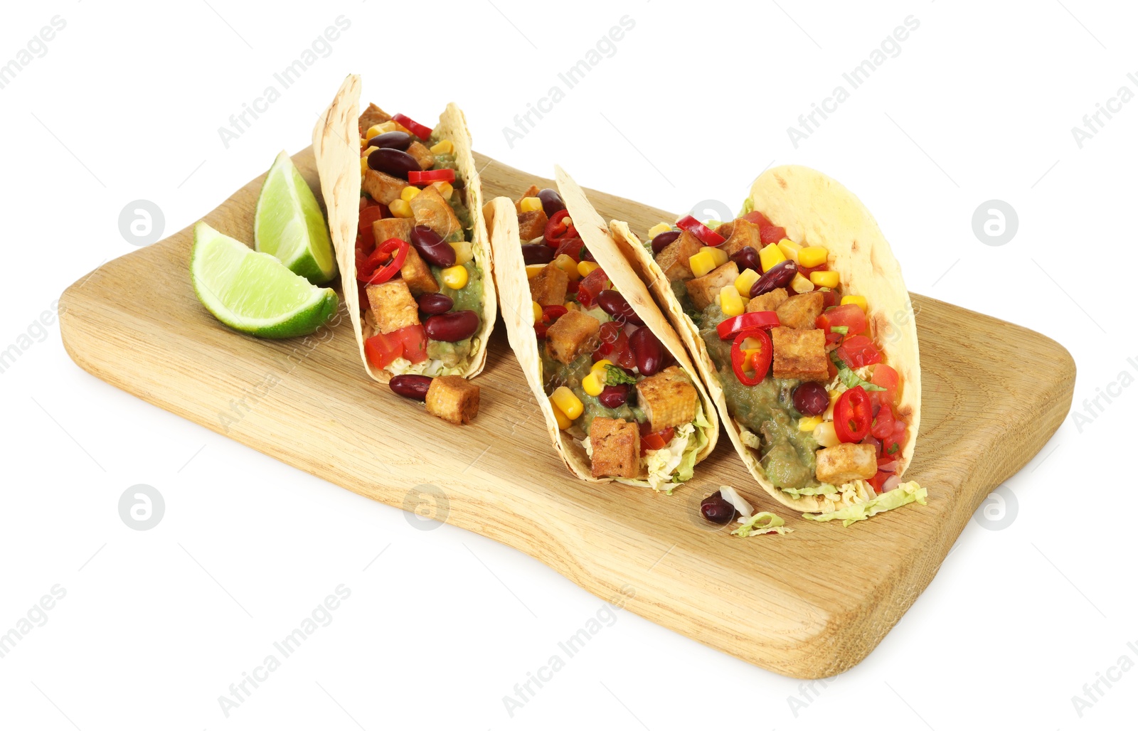 Photo of Tasty vegetarian tacos with beans, tofu, vegetables, guacamole and lime isolated on white