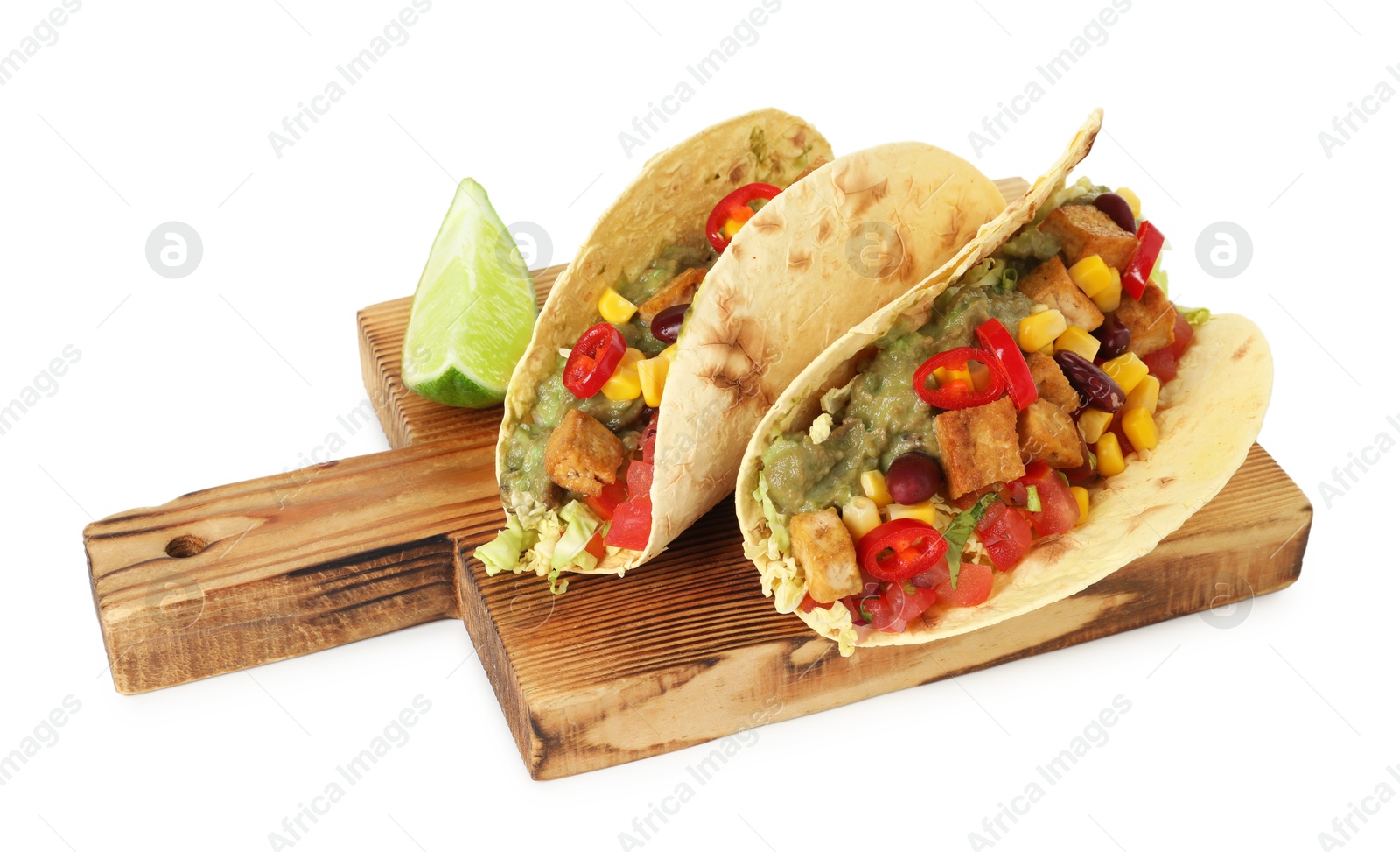 Photo of Tasty vegetarian tacos with beans, tofu, vegetables, guacamole and lime isolated on white