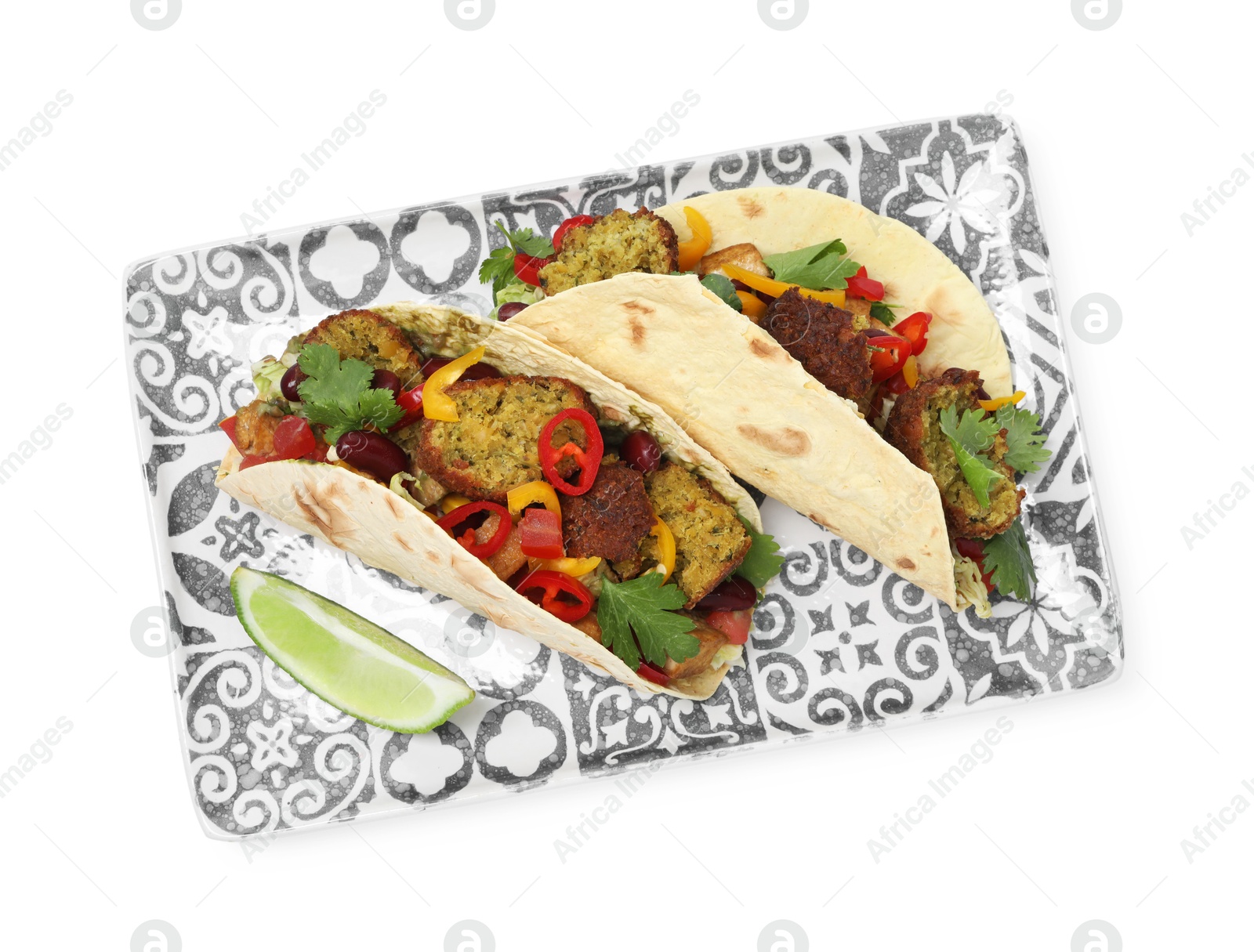 Photo of Tasty vegetarian tacos with falafel, tofu, beans, vegetables and lime isolated on white, top view