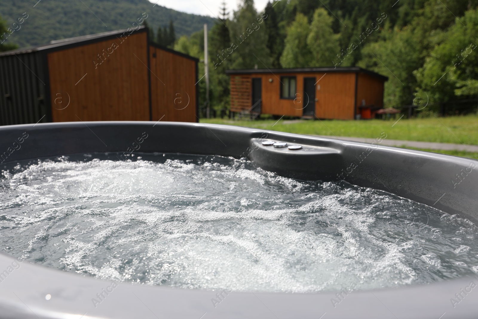Photo of Tub with hot water at luxury resort in mountains, closeup