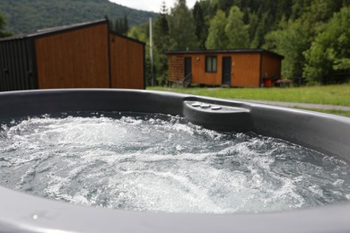 Photo of Tub with hot water at luxury resort in mountains, closeup