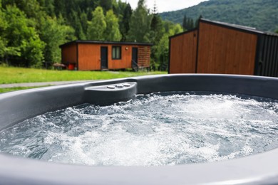 Photo of Tub with hot water at luxury resort in mountains, closeup