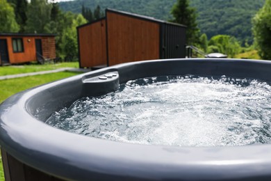 Photo of Tub with hot water at luxury resort in mountains, closeup